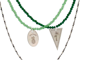 A combo of 3 different necklaces in green tones with crystals, semiprecious stones, silver 925 chain, combined with silver 925 charms in various shapes and with different desings - palm tree, pineapple - and messages like ´´stay sweet´´.