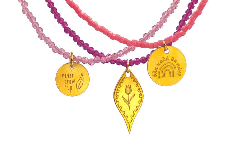 A combo in fucshia tones of 3 different necklaces with miyuki beads, semiprecious stones combined with silver 925 gold plated charms in various shapes and with different desinbgs - tulip - and messages like ´´never grow up´´ and ´´όλα καλά θα πάνε''.