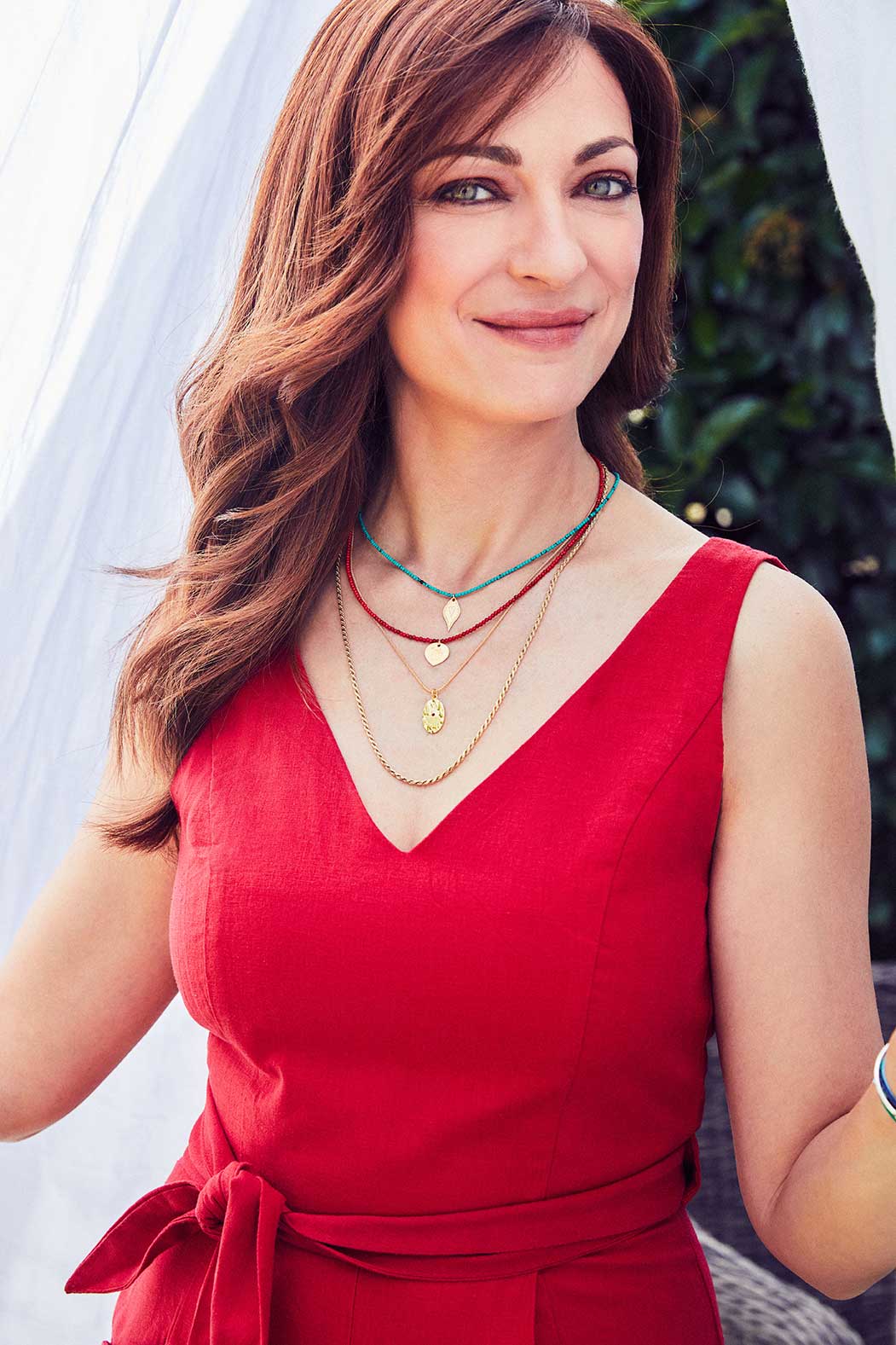 Emily Koliandri is feeling very happy wearing a combo of 4 different necklaces with germstones, silver 925 gold plated chain and silver 925 gold plated charms.
