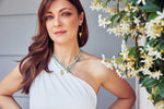 Load image into Gallery viewer, Emily Koliandri in a white dress is wearing 4 different necklaces made of gemstones, miyuki, crystal and white pearls and combined with silver 925 charms with different designs. Also is wearing a silver 925 gold plated earrings with a triangle charm.
