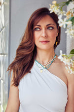 Load image into Gallery viewer, Emily Koliandri in a white dress is wearing 4 different necklaces made of gemstones, miyuki, crystal and white pearls and combined with silver 925 charms with different designs. Also is wearing a silver 925 gold plated earring with a triangle charm.
