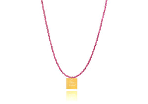 A necklace made of fucshia japanese miyuki beads and a squared silver 925 charm plated in gold 24K, with a message´´όλα λάθος'' -'It's all wrong! .