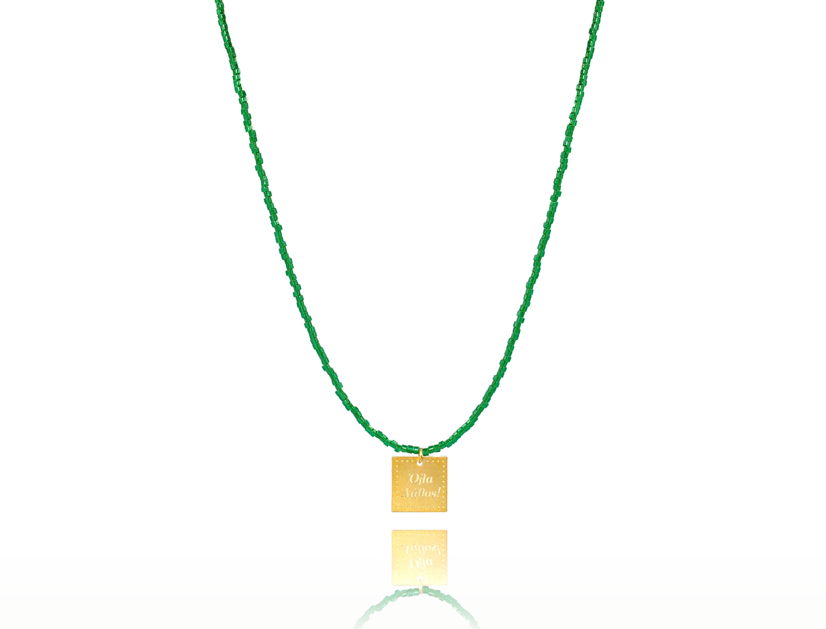 A necklace made of forest green japanese miyuki beads and a squared silver 925 charm plated in gold 24K, with a message ´´όλα λάθος'' -'It's all wrong! .