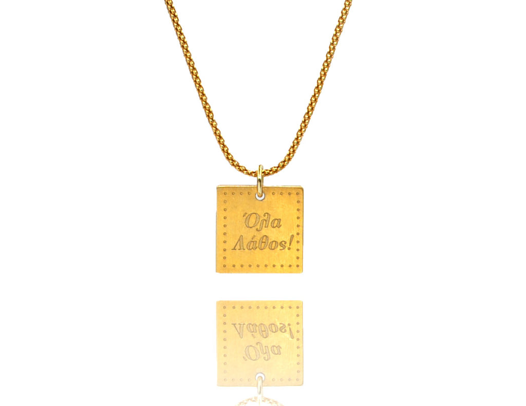 A necklace made of silver 925 gold plated chain and a squared silver 925 charm plated in gold 24K, with a message ´´όλα λάθος'' -'It's all wrong! .
