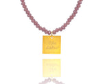 Load image into Gallery viewer, A necklace made of lilac crystal beads and a squared silver 925 charm plated in gold 24K, with a message ´´όλα λάθος&#39;&#39; -&#39;It&#39;s all wrong! .
